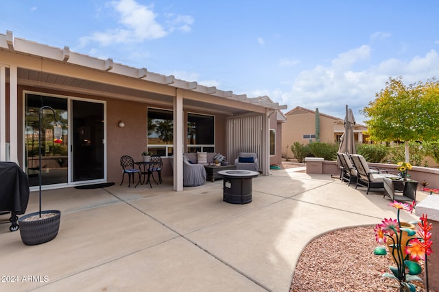 view of patio featuring grilling area and an outdoor living space with a fire pit