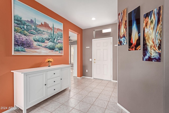 entryway with light tile patterned floors and ceiling fan