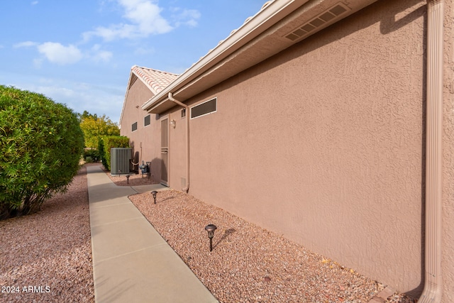 view of side of home featuring central AC