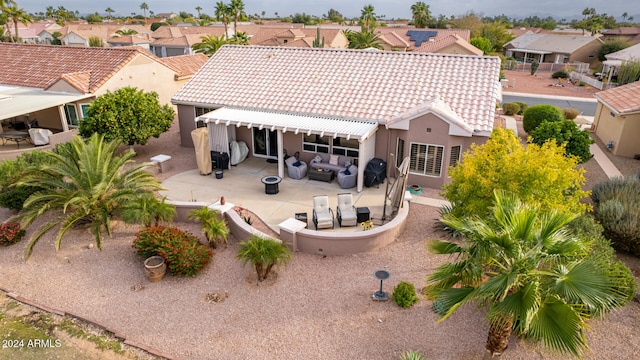 rear view of house featuring an outdoor living space and a patio