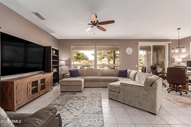 living room featuring ceiling fan and light tile patterned flooring