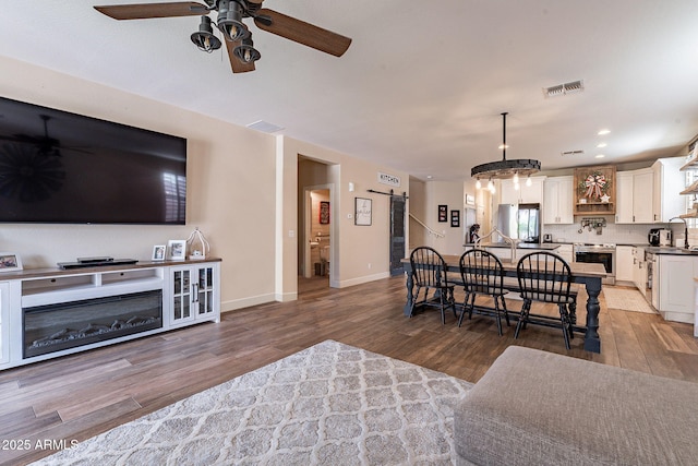 12238 W Patrick Ct, Sun City, AZ 85373 - living area featuring a ceiling fan, wood finished floors, baseboards, and recessed lighting