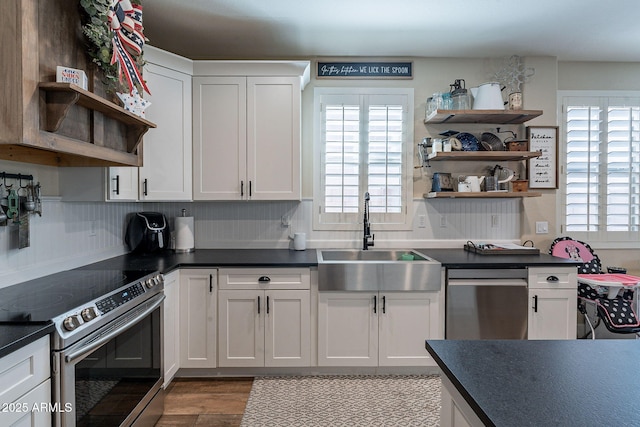 12238 W Patrick Ct, Sun City, AZ 85373 - kitchen featuring open shelves, stainless steel appliances, a sink, and dark countertops