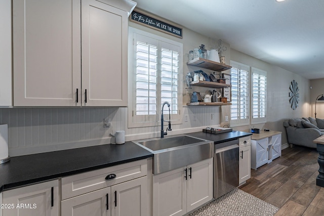12238 W Patrick Ct, Sun City, AZ 85373 - kitchen featuring stainless steel dishwasher, a sink, dark countertops, dark wood finished floors, and white cabinetry