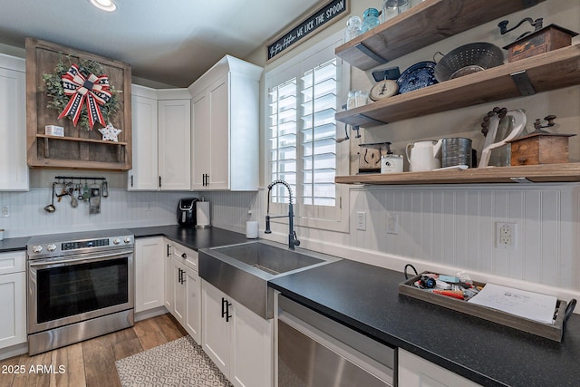 12238 W Patrick Ct, Sun City, AZ 85373 - kitchen featuring open shelves, appliances with stainless steel finishes, a sink, white cabinets, and dark countertops