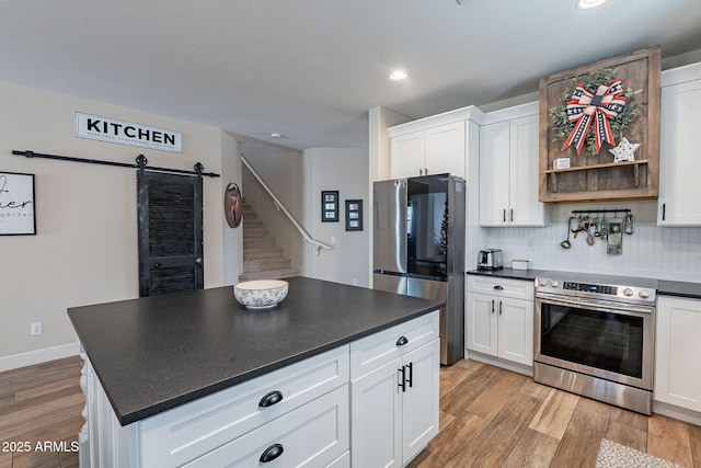 12238 W Patrick Ct, Sun City, AZ 85373 - kitchen with appliances with stainless steel finishes, dark countertops, light wood finished floors, and recessed lighting