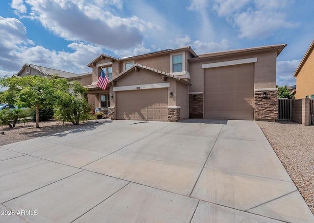 12238 W Patrick Ct, Sun City, AZ 85373 - view of front of house with stone siding, an attached garage, concrete driveway, stucco siding, and fence