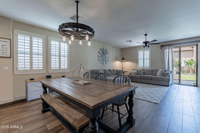 12238 W Patrick Ct, Sun City, AZ 85373 - dining area with dark wood-style floors, ceiling fan, a chandelier, and baseboards