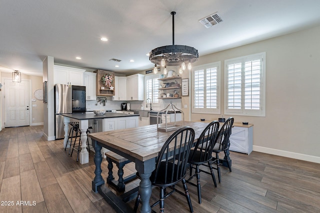 12238 W Patrick Ct, Sun City, AZ 85373 - dining area featuring baseboards, dark wood-style floors, and recessed lighting