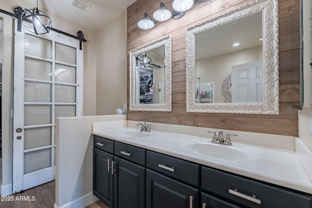 12238 W Patrick Ct, Sun City, AZ 85373 - bathroom featuring wood finished floors, double vanity, and a shower