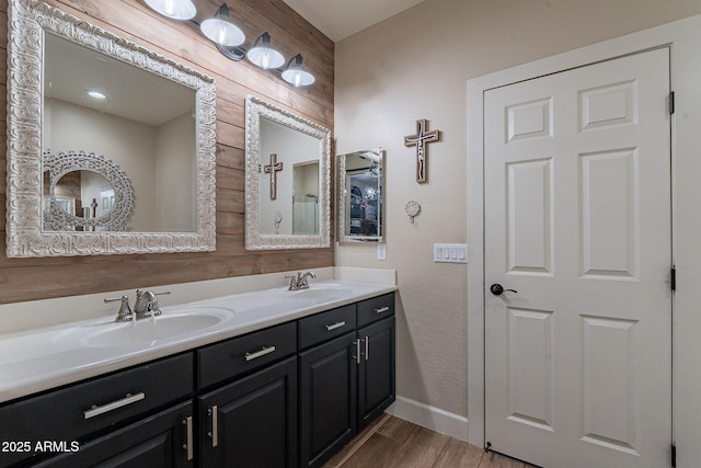 12238 W Patrick Ct, Sun City, AZ 85373 - bathroom with wood finished floors, double vanity, and baseboards