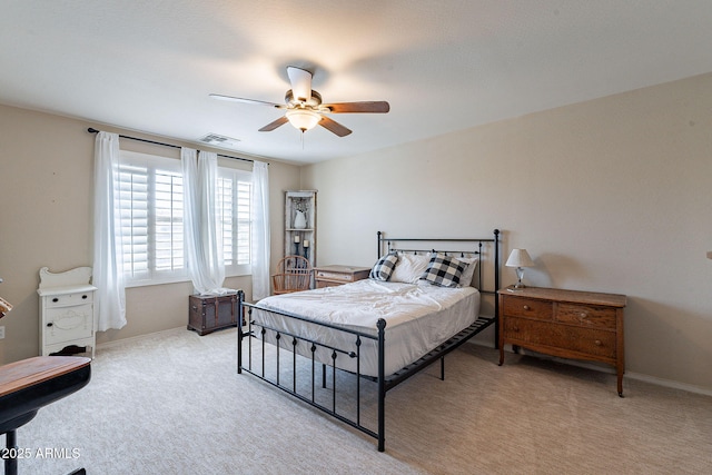 12238 W Patrick Ct, Sun City, AZ 85373 - bedroom with light carpet, a ceiling fan, and baseboards