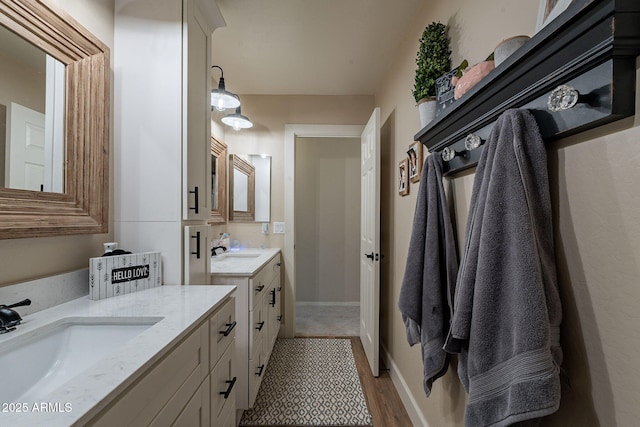 12238 W Patrick Ct, Sun City, AZ 85373 - bathroom featuring two vanities and wood finished floors