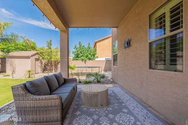 12238 W Patrick Ct, Sun City, AZ 85373 - view of patio / terrace featuring a storage shed, a fenced backyard, an outbuilding, and an outdoor living space