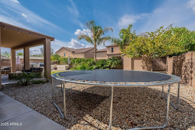 12238 W Patrick Ct, Sun City, AZ 85373 - view of yard featuring a trampoline and fence