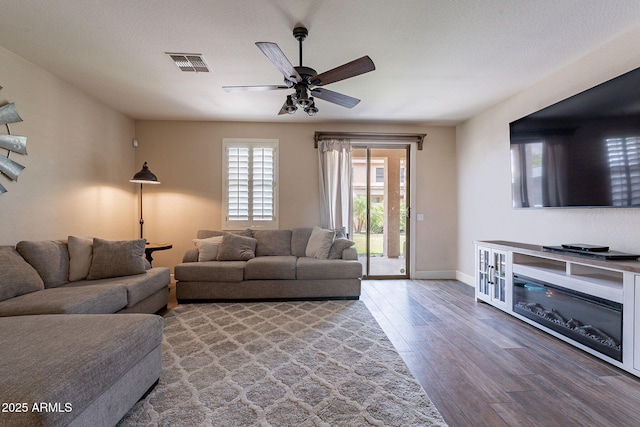12238 W Patrick Ct, Sun City, AZ 85373 - living area with wood finished floors, baseboards, and ceiling fan