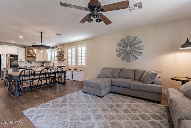 12238 W Patrick Ct, Sun City, AZ 85373 - living area featuring dark wood-type flooring, ceiling fan, and recessed lighting