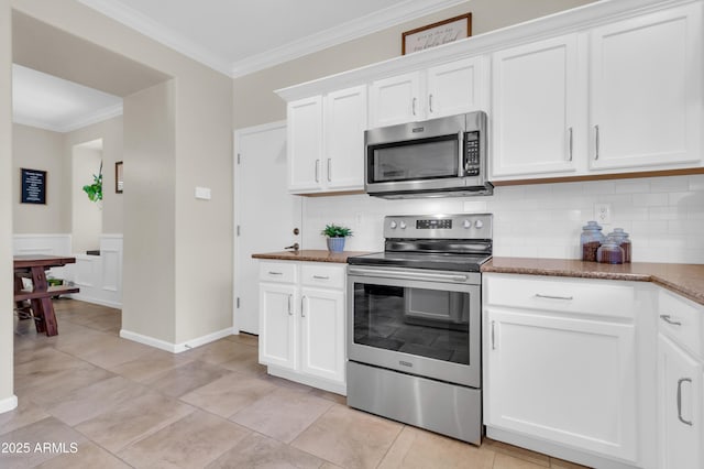 3029 E Patrick St, Gilbert, AZ 85295 - kitchen featuring appliances with stainless steel finishes, crown molding, backsplash, white cabinets, and dark stone counters