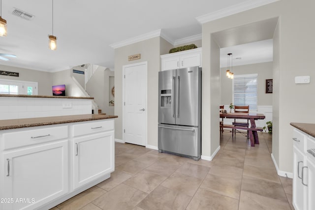 3029 E Patrick St, Gilbert, AZ 85295 - kitchen with stainless steel refrigerator with ice dispenser, dark stone countertops, crown molding, white cabinets, and pendant lighting