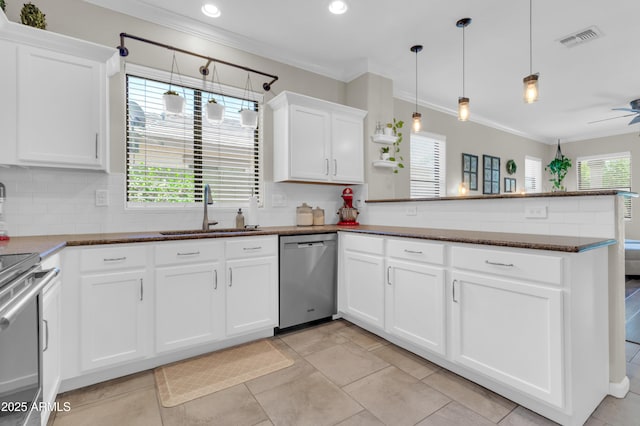 3029 E Patrick St, Gilbert, AZ 85295 - kitchen with stainless steel appliances, a sink, ornamental molding, a peninsula, and white cabinets