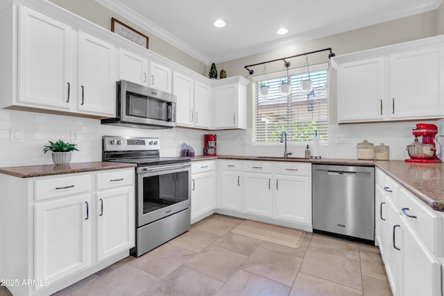 3029 E Patrick St, Gilbert, AZ 85295 - kitchen with stainless steel appliances, a sink, ornamental molding, white cabinets, and decorative backsplash