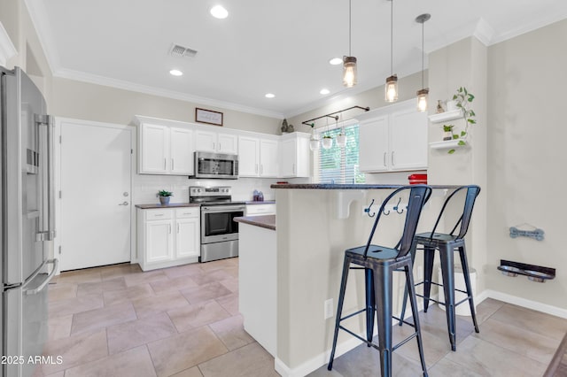 3029 E Patrick St, Gilbert, AZ 85295 - kitchen featuring appliances with stainless steel finishes, dark countertops, open shelves, a kitchen breakfast bar, and white cabinetry