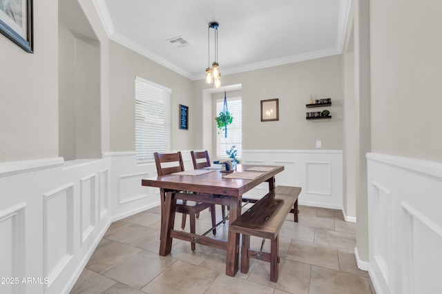3029 E Patrick St, Gilbert, AZ 85295 - dining area featuring a decorative wall, ornamental molding, a wainscoted wall, and light tile patterned floors