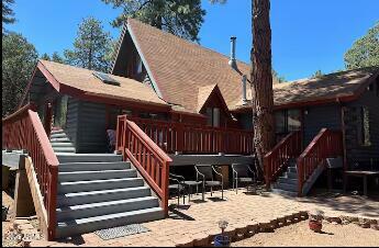 rear view of house featuring a deck, a patio, and stairway