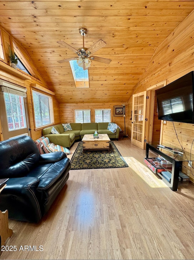 403 W Sherwood Dr, Payson, AZ 85541 - unfurnished living room featuring wooden walls, ceiling fan, wood finished floors, vaulted ceiling with skylight, and wooden ceiling