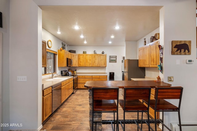 6523 Wild Cat Way, Pinetop, AZ 85935 - kitchen with appliances with stainless steel finishes, light wood-type flooring, a baseboard heating unit, a peninsula, and recessed lighting