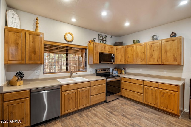 6523 Wild Cat Way, Pinetop, AZ 85935 - kitchen with appliances with stainless steel finishes, a sink, wood finished floors, light countertops, and recessed lighting