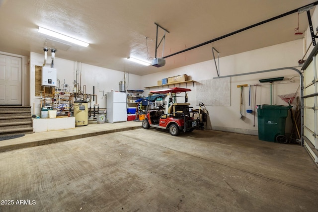 6523 Wild Cat Way, Pinetop, AZ 85935 - garage featuring freestanding refrigerator, tankless water heater, and a garage door opener