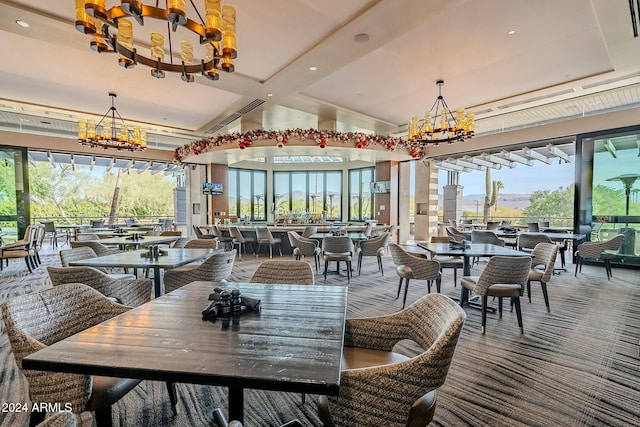 dining area with carpet floors and an inviting chandelier