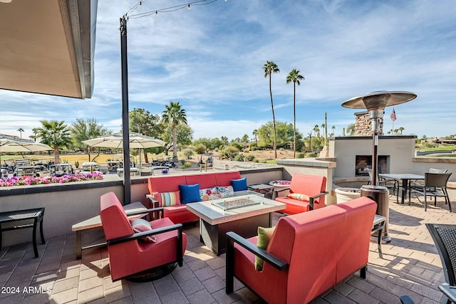 view of patio / terrace with an outdoor living space with a fireplace