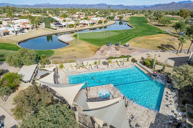 view of swimming pool with a water and mountain view