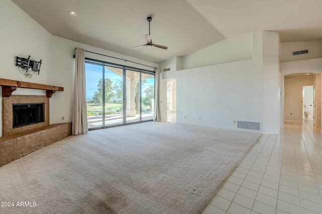 unfurnished living room featuring a fireplace, high vaulted ceiling, ceiling fan, and light tile patterned flooring