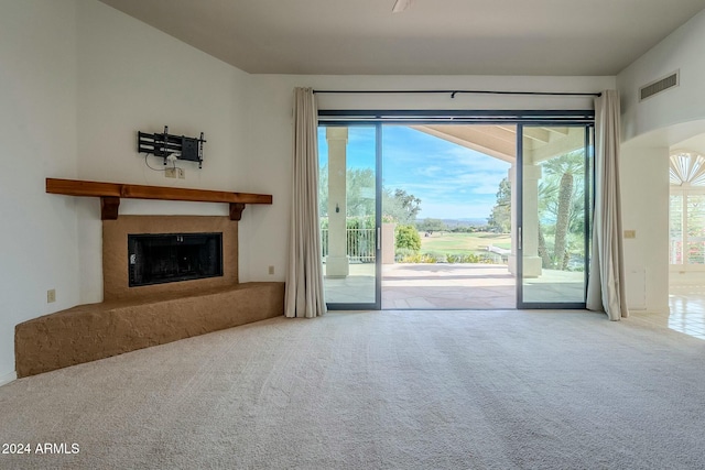 unfurnished living room featuring carpet and a premium fireplace