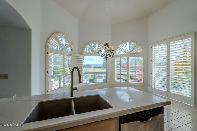 kitchen with dishwasher, sink, hanging light fixtures, an inviting chandelier, and light tile patterned flooring