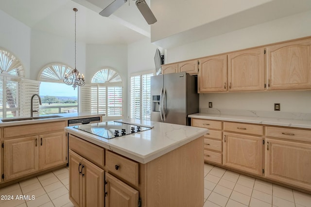 kitchen with light brown cabinets, a center island, sink, stainless steel fridge, and light tile patterned floors