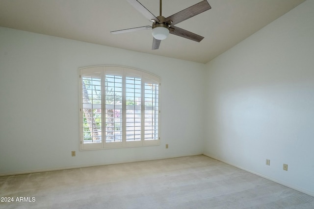 carpeted empty room featuring ceiling fan and lofted ceiling