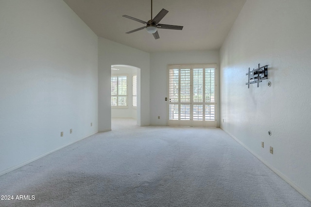 carpeted spare room featuring ceiling fan