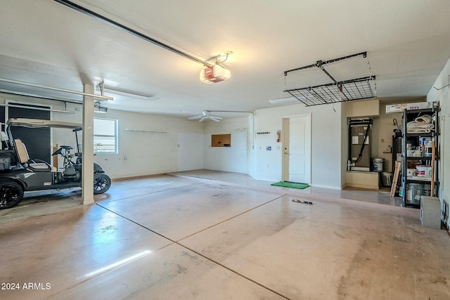 garage with a garage door opener and ceiling fan