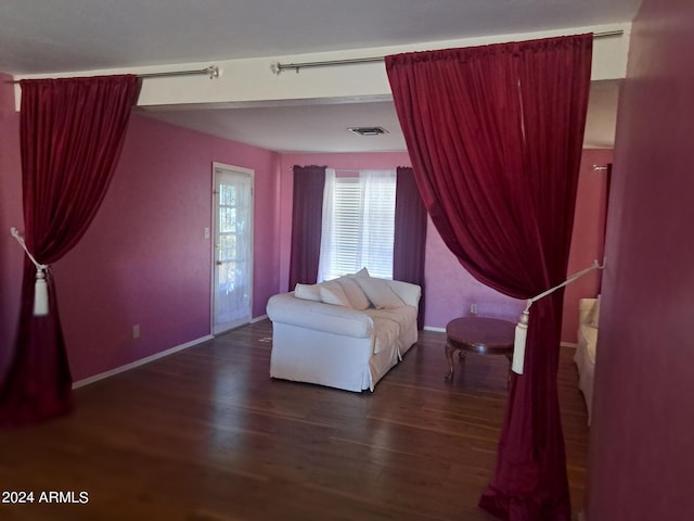 sitting room featuring visible vents, baseboards, and wood finished floors