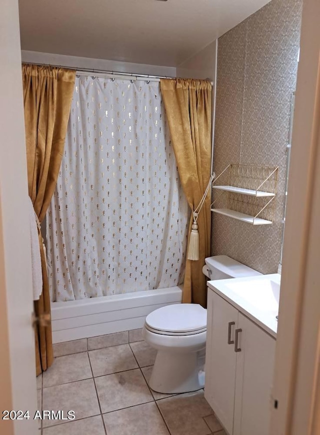 full bathroom featuring tile patterned floors, shower / bath combo with shower curtain, vanity, and toilet