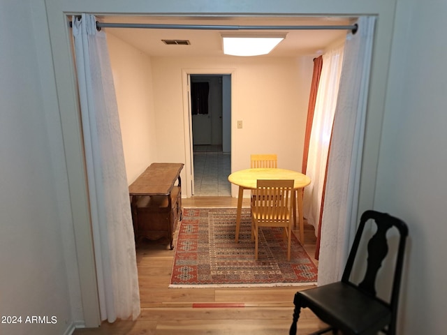 dining area featuring visible vents and wood finished floors