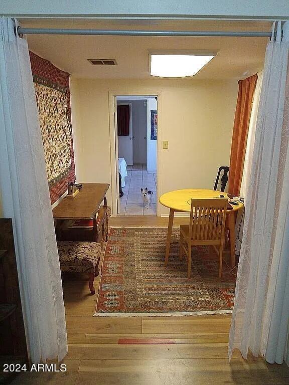 dining room featuring wood finished floors and visible vents