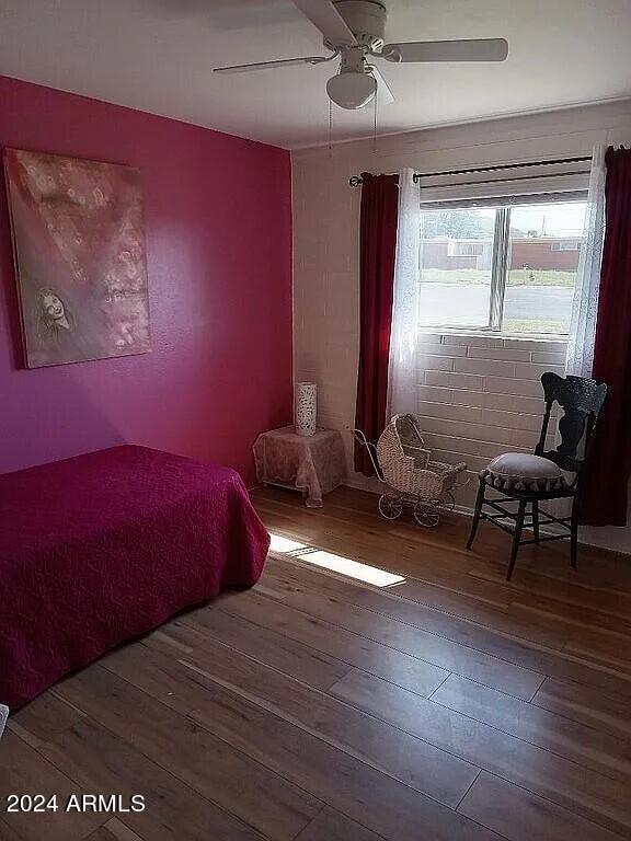 bedroom with wood-type flooring and ceiling fan