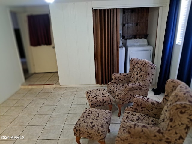 sitting room featuring independent washer and dryer and light tile patterned flooring