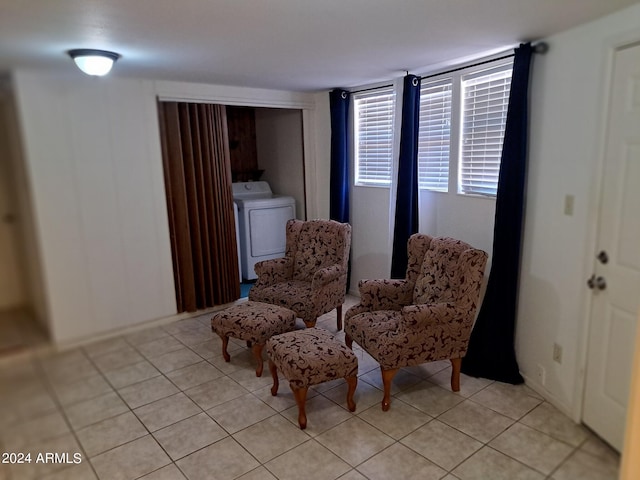 sitting room featuring washer / dryer and light tile patterned flooring