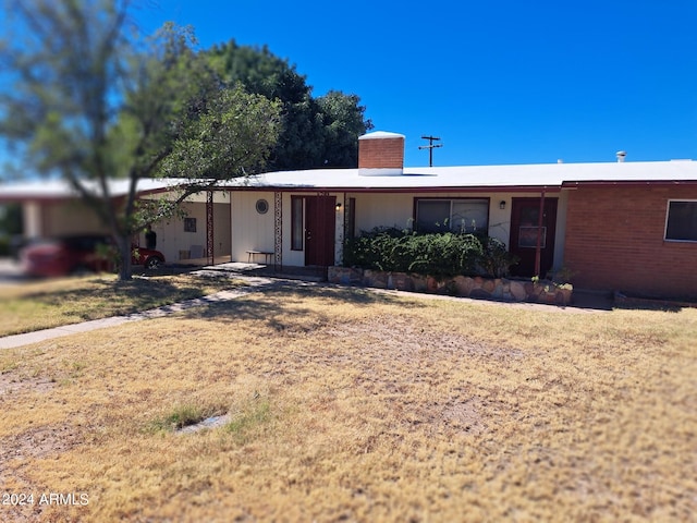 ranch-style house featuring a chimney